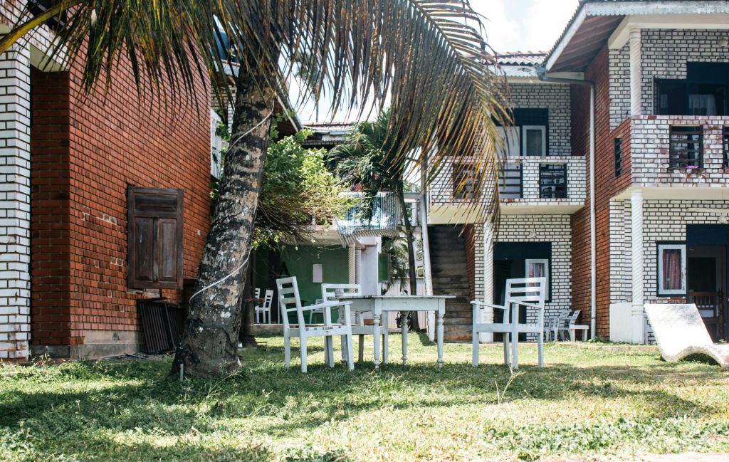 A table and chairs sit in front of buildings.